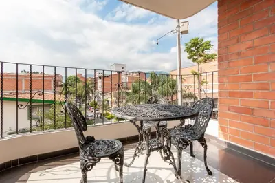 a patio with a table and chairs on a balcony at ¡Apartamento HOME LAURELES excelente ubicación! in Medellín