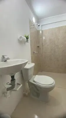 a bathroom with a toilet and a sink and a shower at APARTAHOTEL ESTADIO GOLD in Medellín