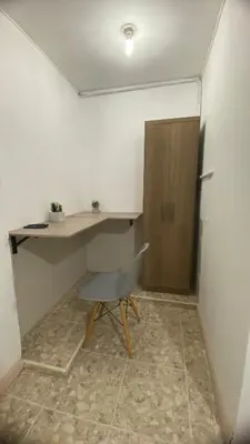a desk and a chair in a room at APARTAHOTEL ESTADIO GOLD in Medellín