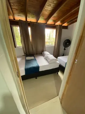 a small room with a bed and a window at APARTAHOTEL ESTADIO GOLD in Medellín