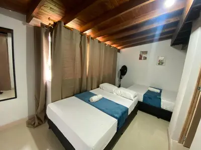 a bedroom with two beds in a room at APARTAHOTEL ESTADIO GOLD in Medellín