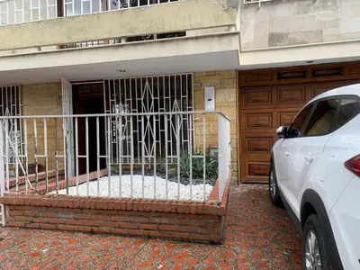 a gate in front of a building with a door at APARTAHOTEL ESTADIO GOLD in Medellín