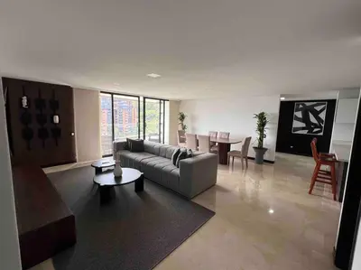 a living room with a couch and a table at 501 Luxury Apartment In Heart Of El Poblado in Medellín