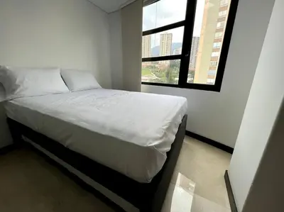 a white bed in a room with a window at 501 Luxury Apartment In Heart Of El Poblado in Medellín