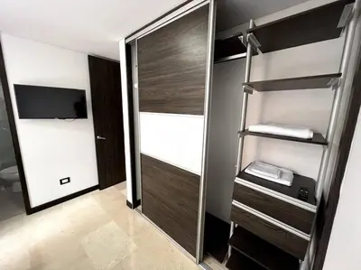 a walk in closet with a mirror in a room at 501 Luxury Apartment In Heart Of El Poblado in Medellín