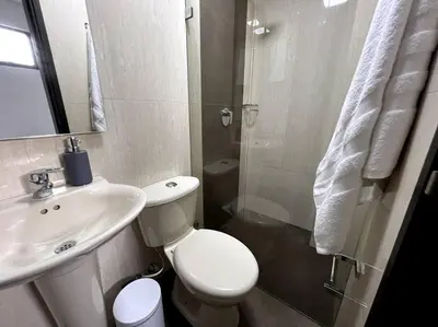 a bathroom with a toilet and a sink and a shower at 501 Luxury Apartment In Heart Of El Poblado in Medellín