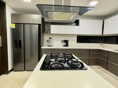 a kitchen with a stove and a refrigerator at 1401, Luxury Penthouse In El Poblado in Medellín