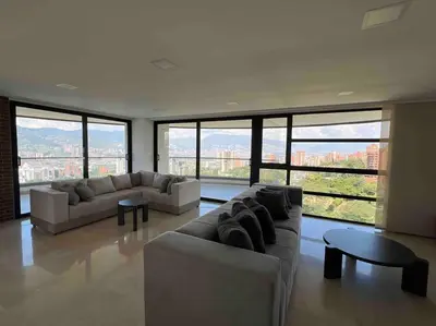 a living room with couches and a table and large windows at 1401, Luxury Penthouse In El Poblado in Medellín
