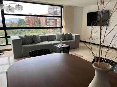 a living room with a couch and a table at 602, Modern apartment in heart of El Poblado + View! in Medellín