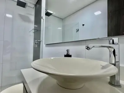 a bathroom with a white sink and a mirror at 602, Modern apartment in heart of El Poblado + View! in Medellín