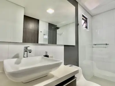 a white bathroom with a sink and a shower at 602, Modern apartment in heart of El Poblado + View! in Medellín