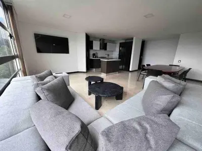 a living room with a couch and a table at 802, Amazing apartment in heart of El Poblado + View! in Medellín
