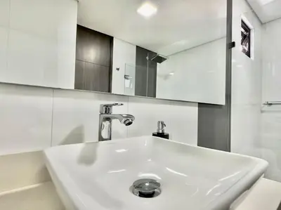 a white sink in a bathroom with a mirror at 802, Amazing apartment in heart of El Poblado + View! in Medellín