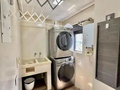 a small kitchen with a washing machine and a sink at 802, Amazing apartment in heart of El Poblado + View! in Medellín