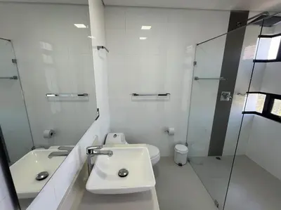 a bathroom with a sink and a toilet and a mirror at 1202, Central Apartment in El Poblado + View in Medellín