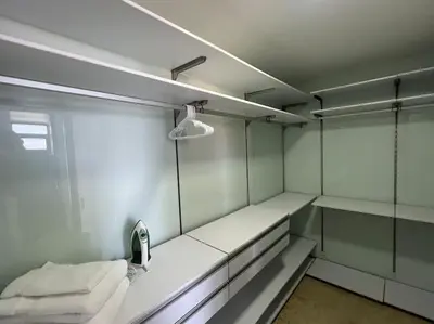 a room with white shelves and a mirror at 1202, Central Apartment in El Poblado + View in Medellín