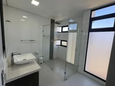 a bathroom with a glass shower and a sink at 1202, Central Apartment in El Poblado + View in Medellín