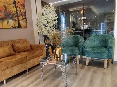 a living room with a couch and two chairs and a table at Provenza Medellin Hotel Boutique in Medellín