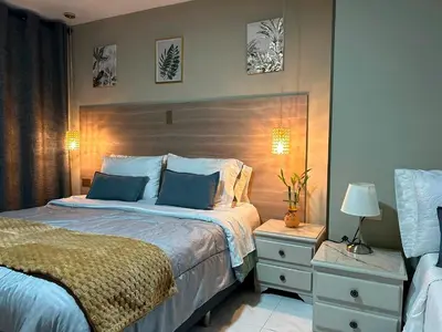 a bedroom with a large bed with blue pillows at Provenza Medellin Hotel Boutique in Medellín