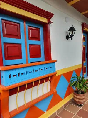a house with colorful walls and a potted plant at Apartamento Corona in Confines