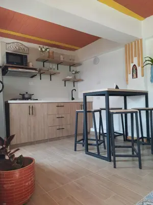 a kitchen with a table and two stools at Apartamento Corona in Confines