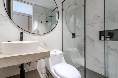a white bathroom with a sink and a mirror at San Telmo Lake Guatape view in Guatapé