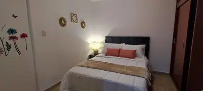 a bedroom with a bed with two pillows on it at Familiar y acogedor in Medellín