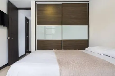 a bedroom with a large bed with a large window at 301 Modern space in exclusive area of El Poblado in Medellín