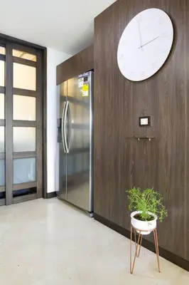a room with a clock on the wall and a plant at 301 Modern space in exclusive area of El Poblado in Medellín