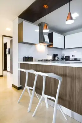 a kitchen with a white table and two chairs at 301 Modern space in exclusive area of El Poblado in Medellín