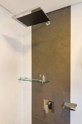a shower with a glass shelf in a bathroom at 301 Modern space in exclusive area of El Poblado in Medellín