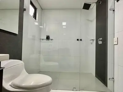 a white bathroom with a shower and a toilet at 302 Spacious apartment nice view in El Poblado in Medellín