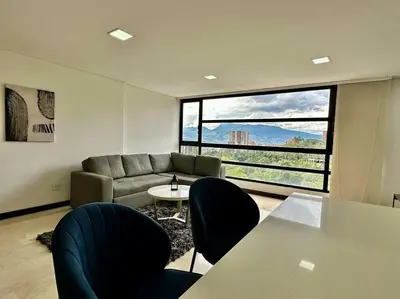 a living room with a couch and a table and chairs at 302 Spacious apartment nice view in El Poblado in Medellín