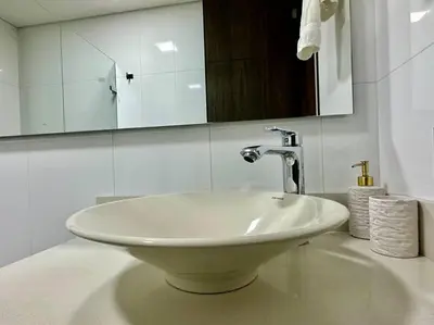 a bathroom with a white sink and a mirror at 302 Spacious apartment nice view in El Poblado in Medellín