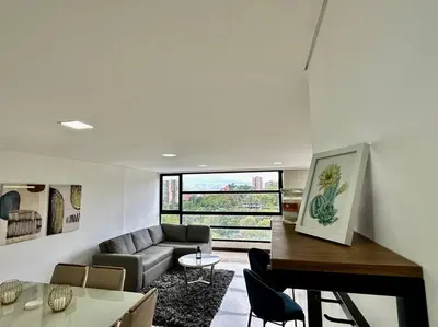 a living room with a couch and a piano at 302 Spacious apartment nice view in El Poblado in Medellín
