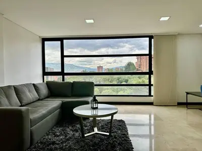a living room with a couch and a table at 302 Spacious apartment nice view in El Poblado in Medellín