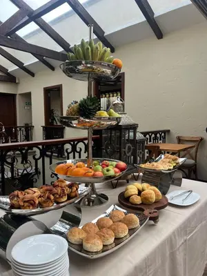 a table topped with different types of food on plates at WR Boutique Hotel in Jardin
