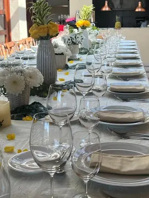 a long table with empty wine glasses on it at WR Boutique Hotel in Jardin