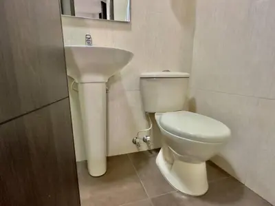 a bathroom with a white toilet and a sink at 502 El Poblado: Beautiful & ample space for families in Medellín