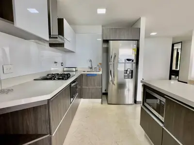 a kitchen with a stainless steel refrigerator in it at 502 El Poblado: Beautiful & ample space for families in Medellín