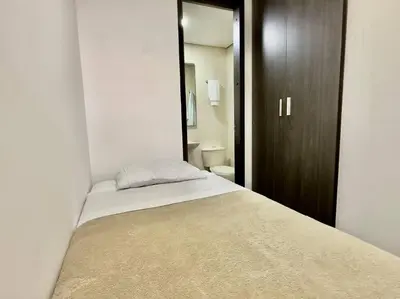 a bedroom with a bed and a bathroom at 502 El Poblado: Beautiful & ample space for families in Medellín