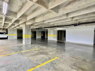 an empty parking garage with a car parked in it at 502 El Poblado: Beautiful & ample space for families in Medellín