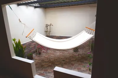 a hammock in a room with a courtyard at Confortable casa tradicional in San Carlos