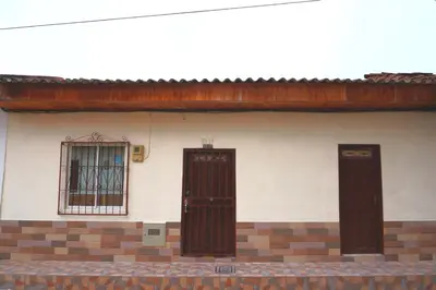 two doors on the side of a house with a window at Confortable casa tradicional in San Carlos