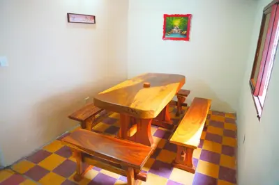 a wooden table and benches in a room at Confortable casa tradicional in San Carlos
