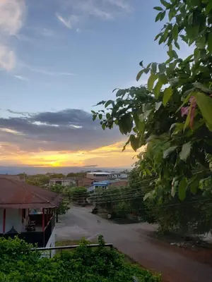 a view of a street with the sunset in the background at Hotel Chicala salgar in Puerto Salgar