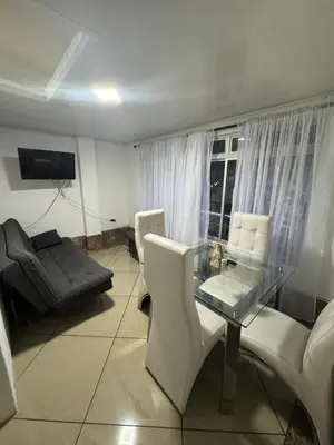 a living room with a glass table and a couch at Laurel Dorado apartotel in Medellín