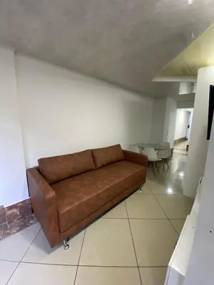 a brown couch sitting in a living room at Laurel Dorado apartotel in Medellín
