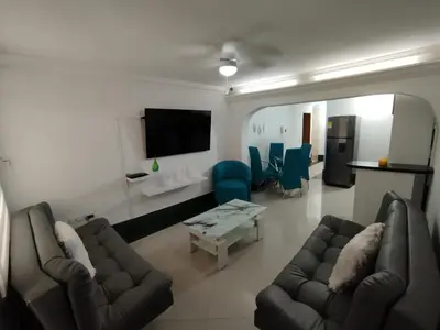 a living room with couches and a table and a tv at Laurel Dorado apartotel in Medellín