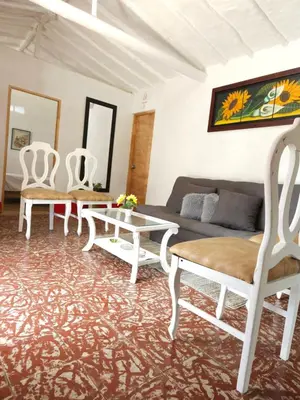 a living room with white chairs and a couch at Casa De Campo 